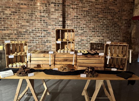 Bespoke wedding dessert table installation at Kinkell Byre, St Andrews, featuring a bountiful display of luxury treats, artisanal cupcakes, and rustic-luxe styling by Crumbdidilyumptious.