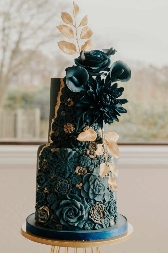 Luxury wedding cake in Stirling featuring dark textural tiers and intricate sugar flower artistry for a bespoke wedding at Stirling Castle or Inglewood House.
