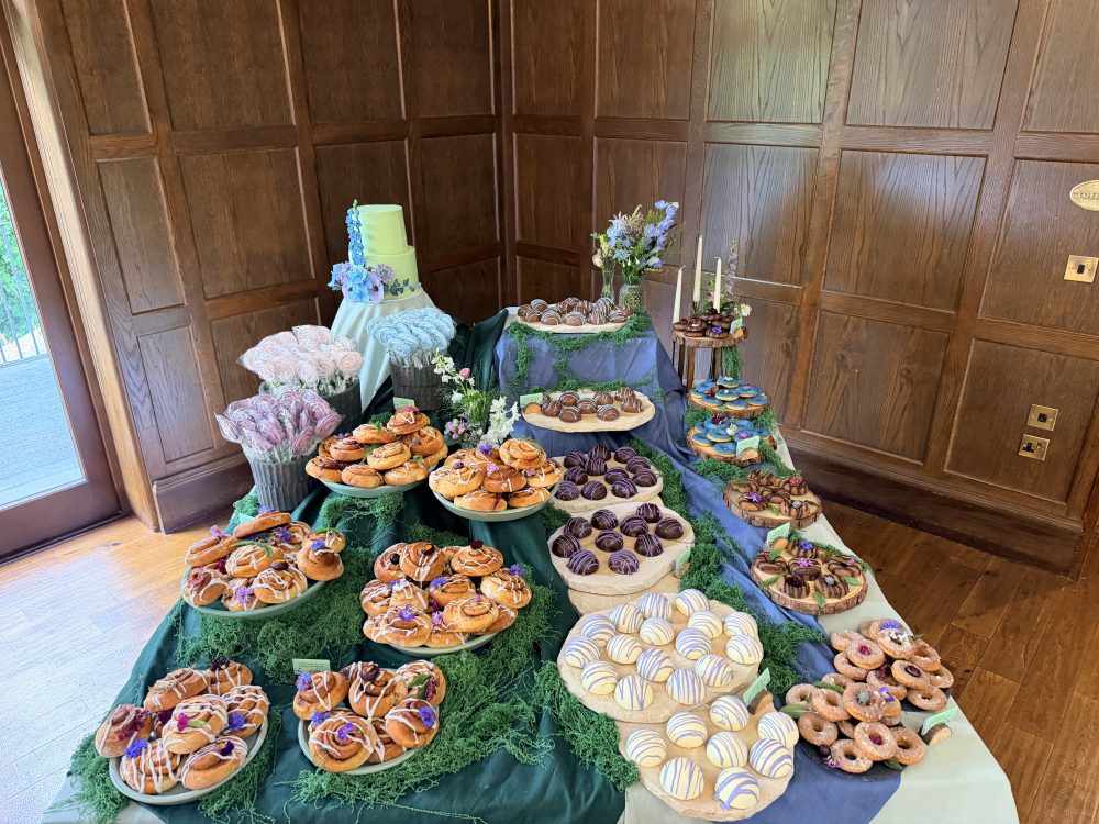 Luxury meadow garden wedding dessert table styling featuring bespoke artisan bakes, stacked natural stone, and moss by Crumbdidilyumptious in Scotland.