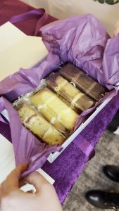 Bespoke wedding cake tasting slices - four flavours in pale blue gift box with purple tissue packaging