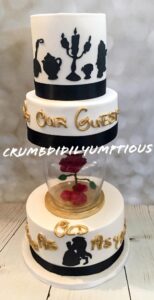 Beauty and the Beast wedding cake with suspended enchanted rose between tiers
