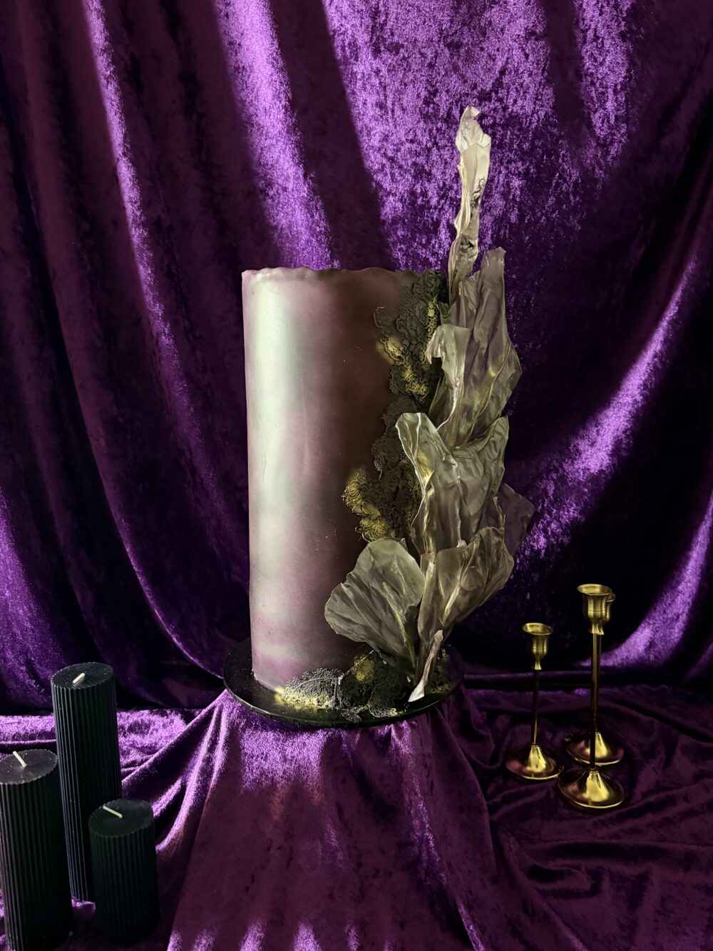 Dramatic sculptural wedding cake with black edible lace, metallic gold detailing and wafer paper sails by Crumbdidilyumptious.