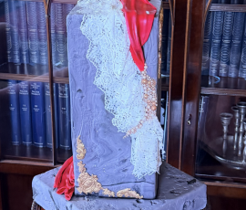 Bespoke sculptural wedding cake featuring delicate lace detailing on display at Bardmony Estate